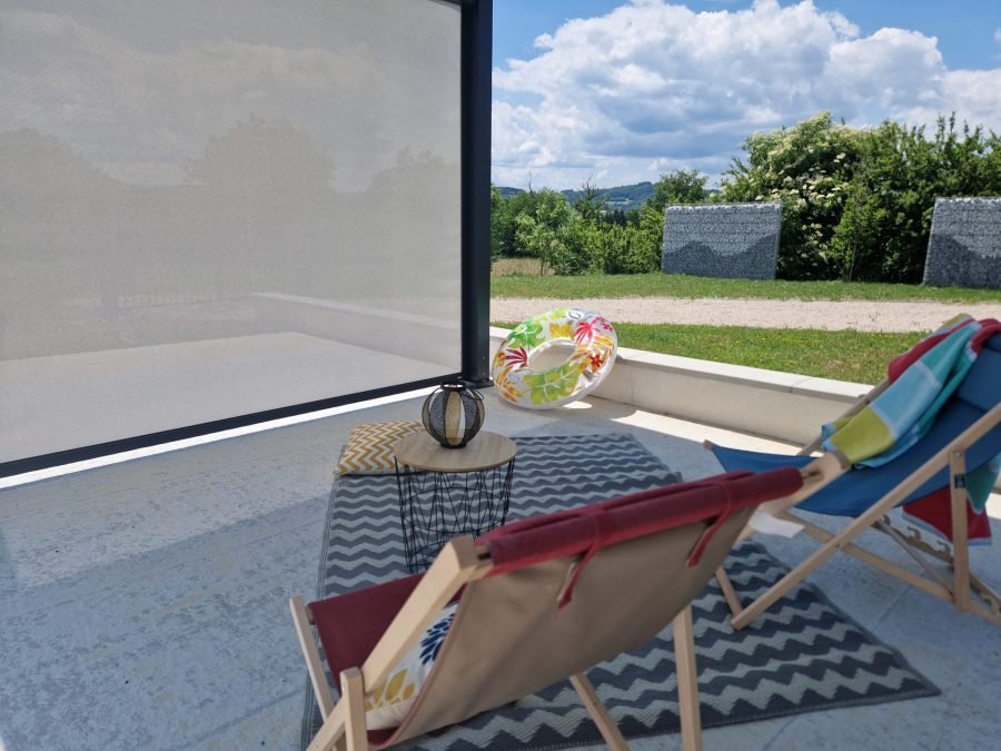 Vue sous une pergola avec store baissé